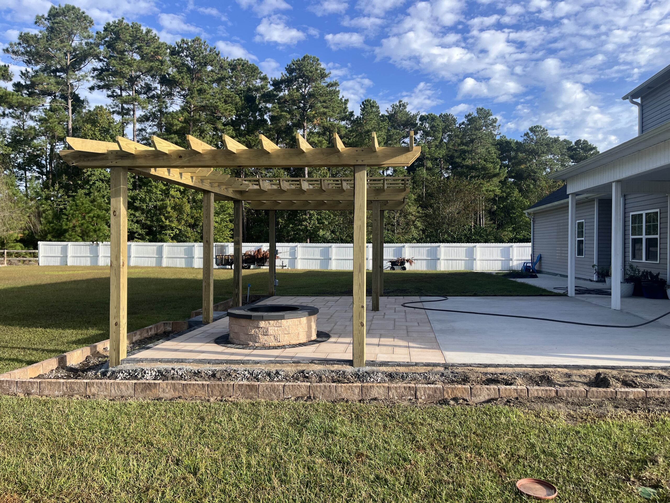 Backyard patio with pergola and fire pit