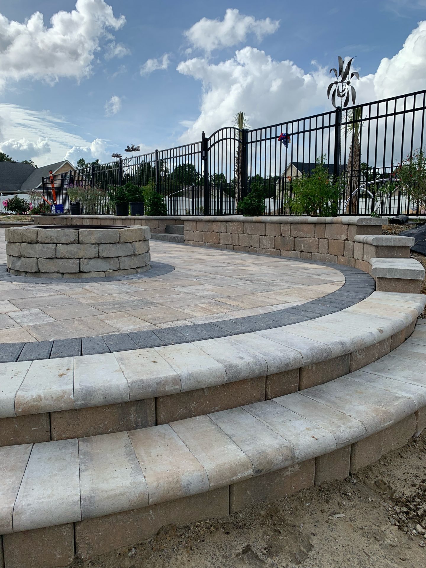 Stone patio with steps and decorative fence.