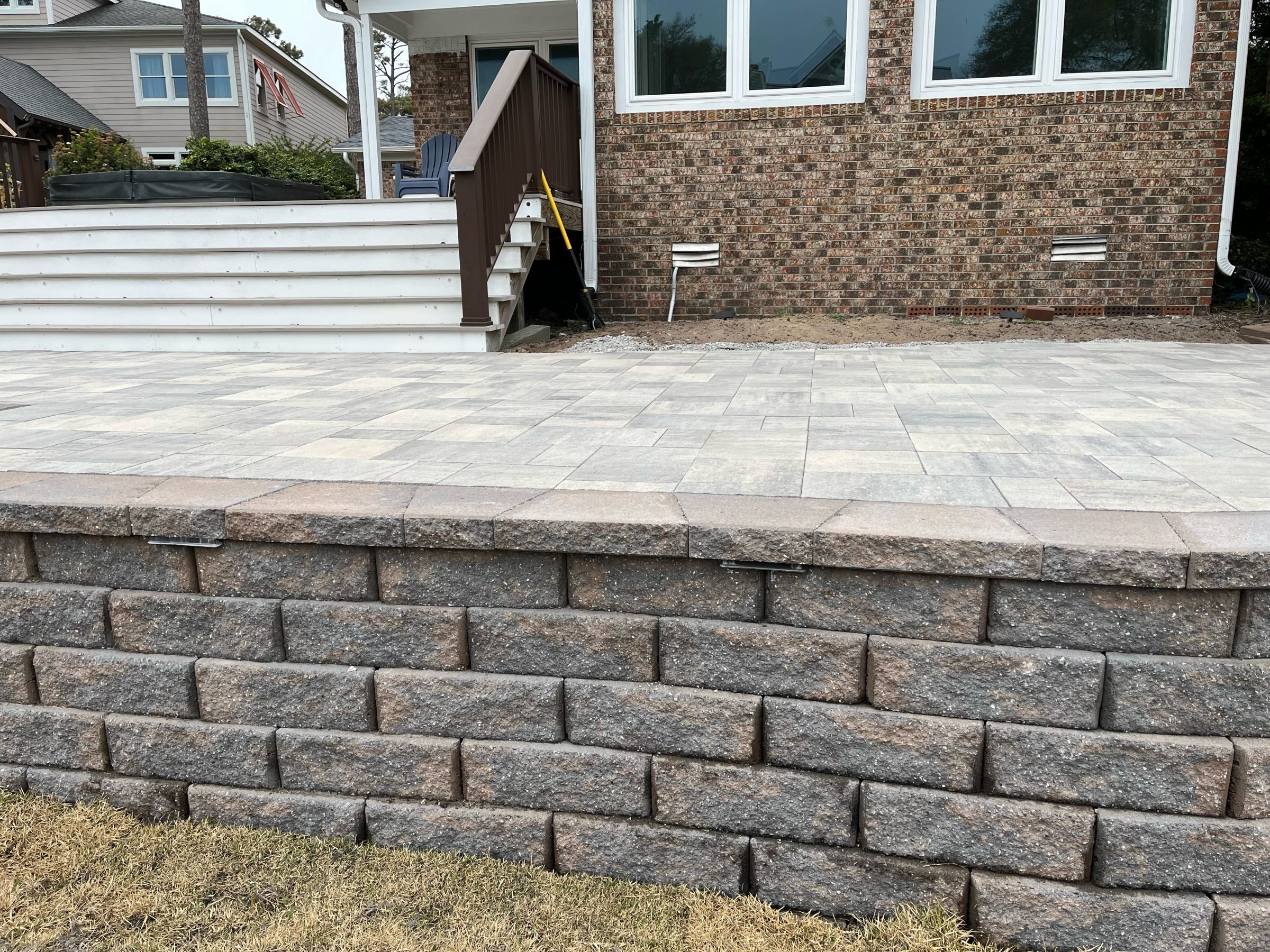 Brick patio with retaining wall and steps.