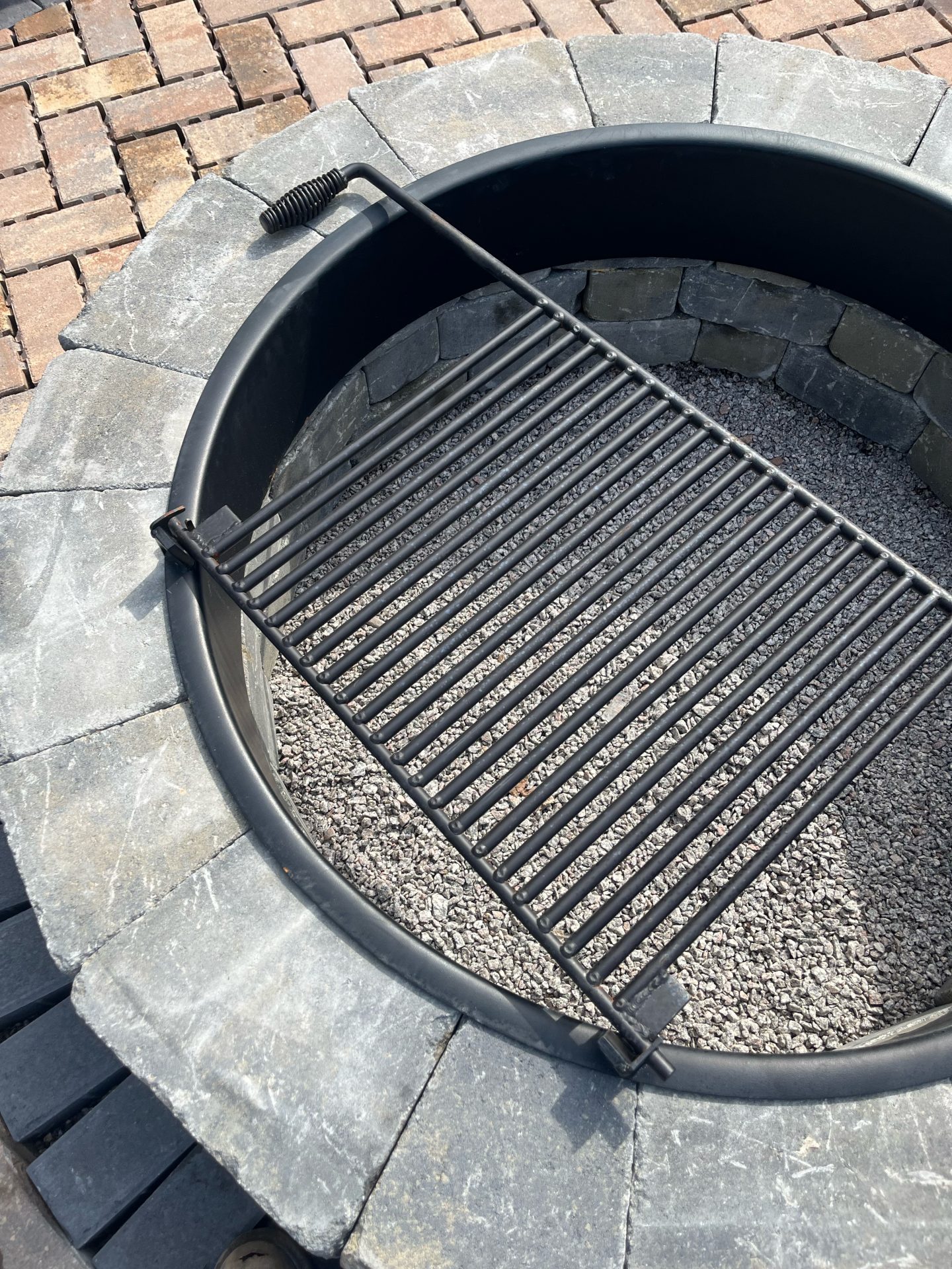 Outdoor fire pit with metal grill insert
