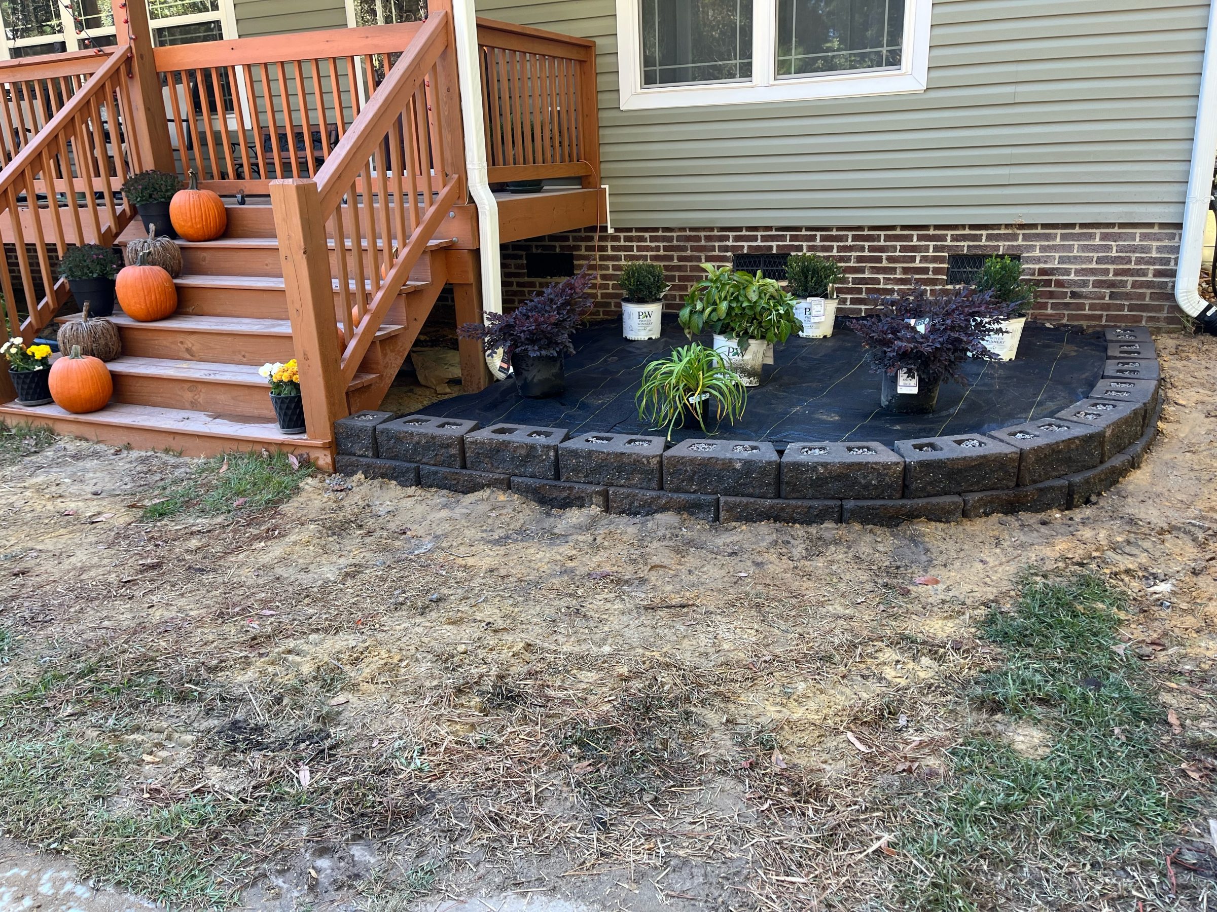 Front porch with pumpkins and newly planted garden