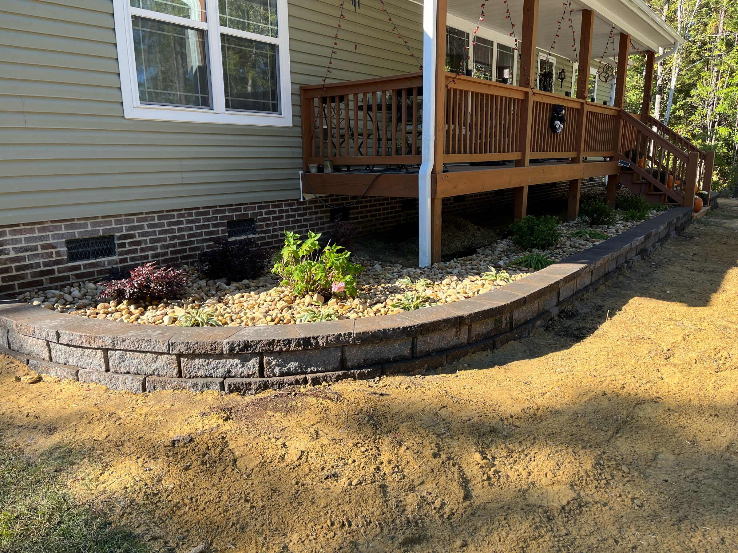 Landscaped garden with stone border and plants.