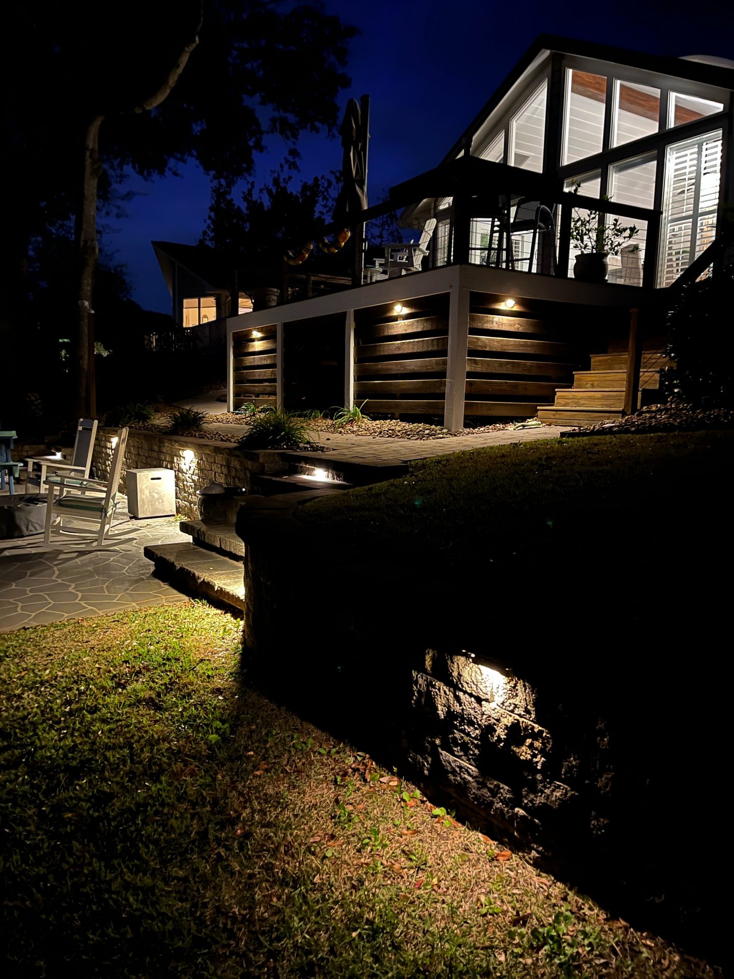 Modern house with outdoor lighting at night.