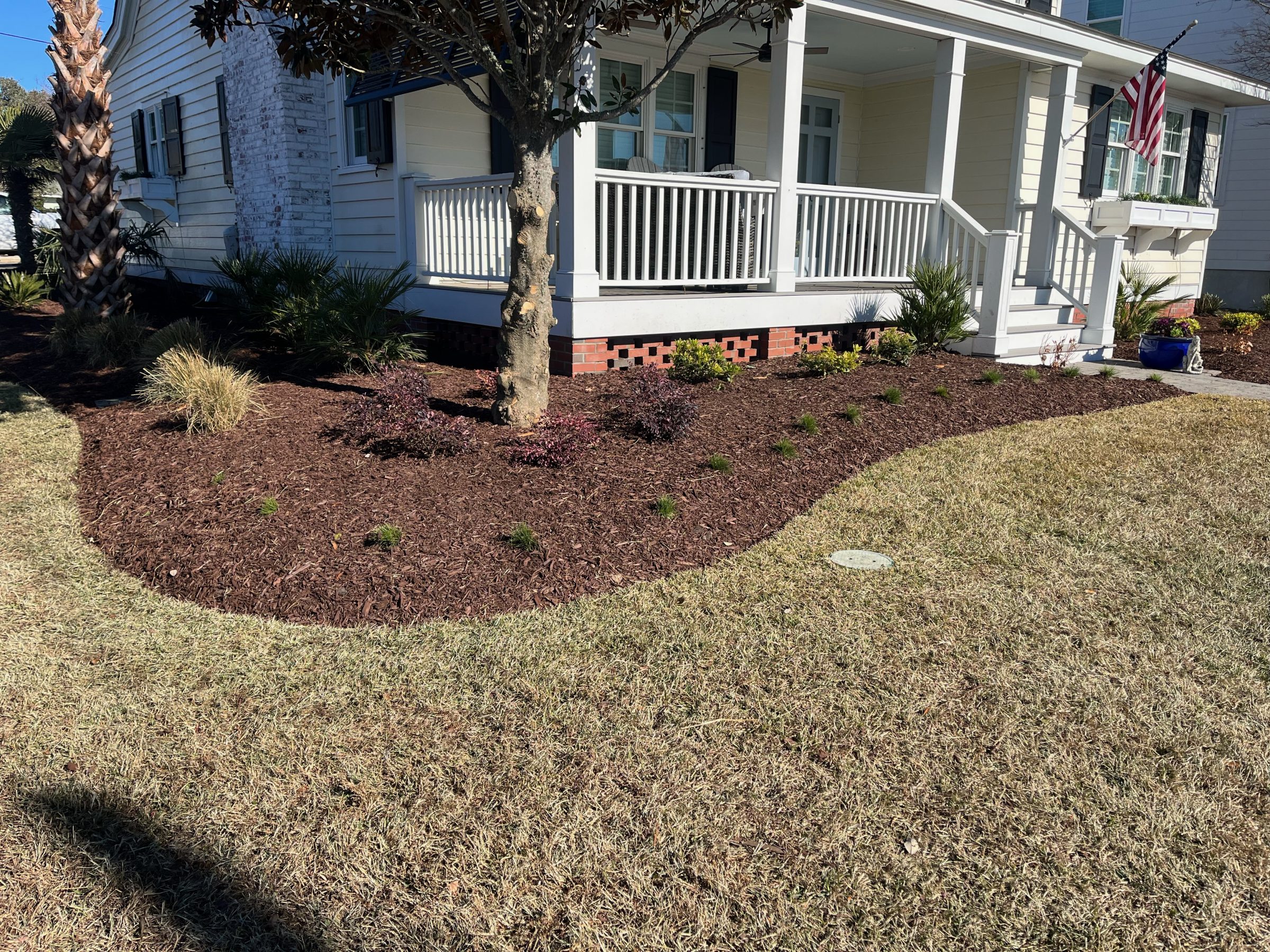 House with landscaped yard and American flag