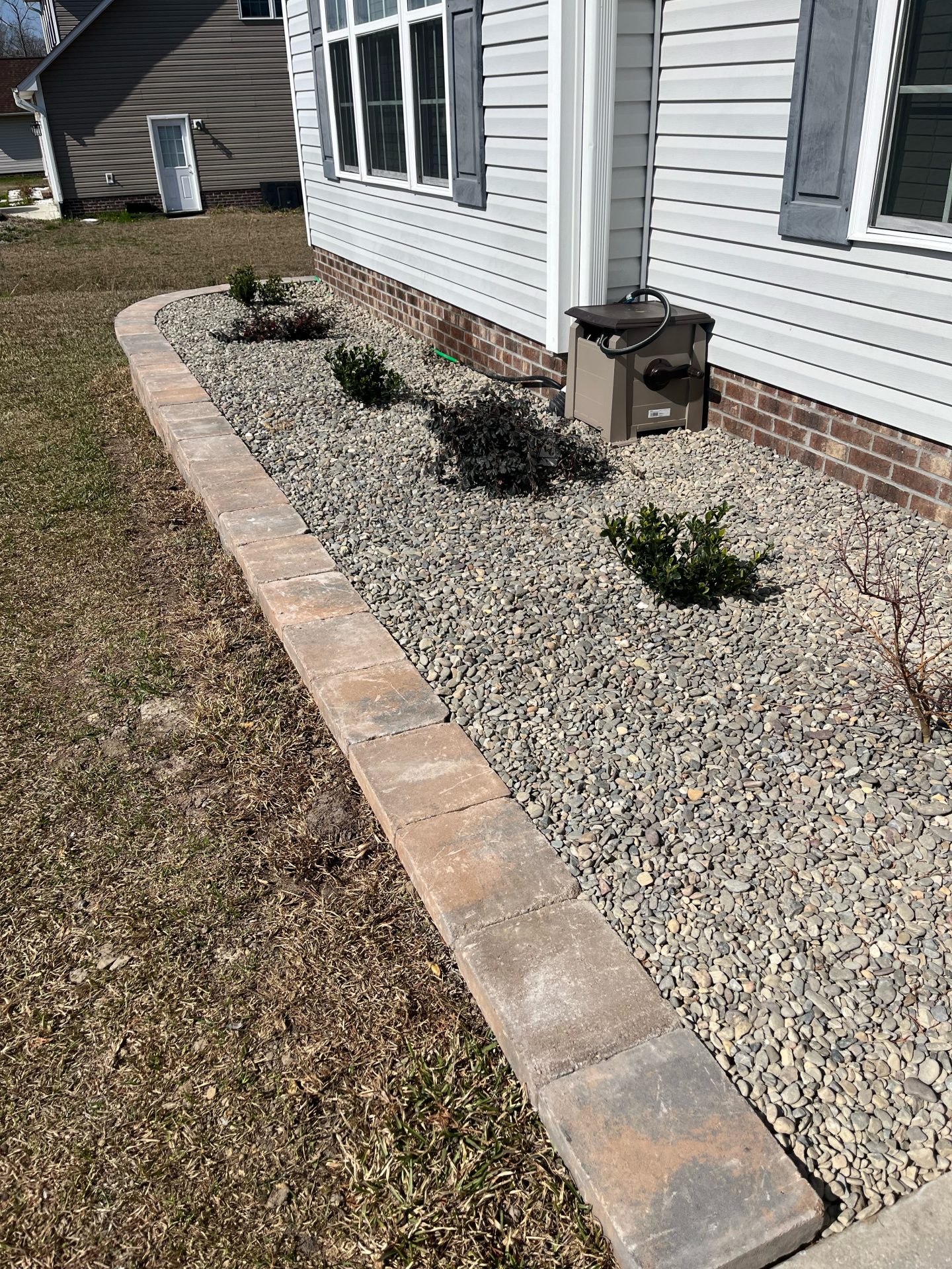 Residential garden with gravel and brick border