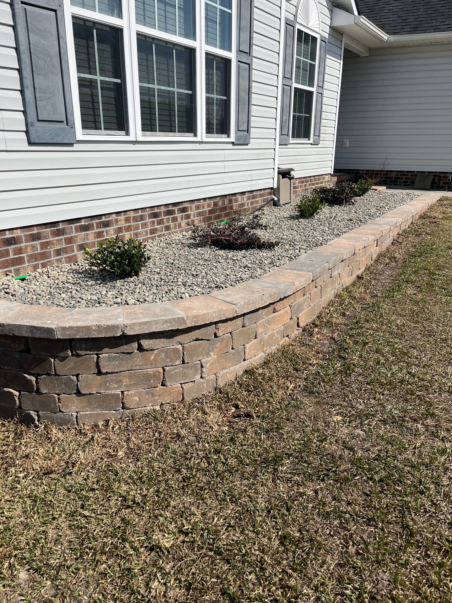 Elegant stone landscaping around house exterior.