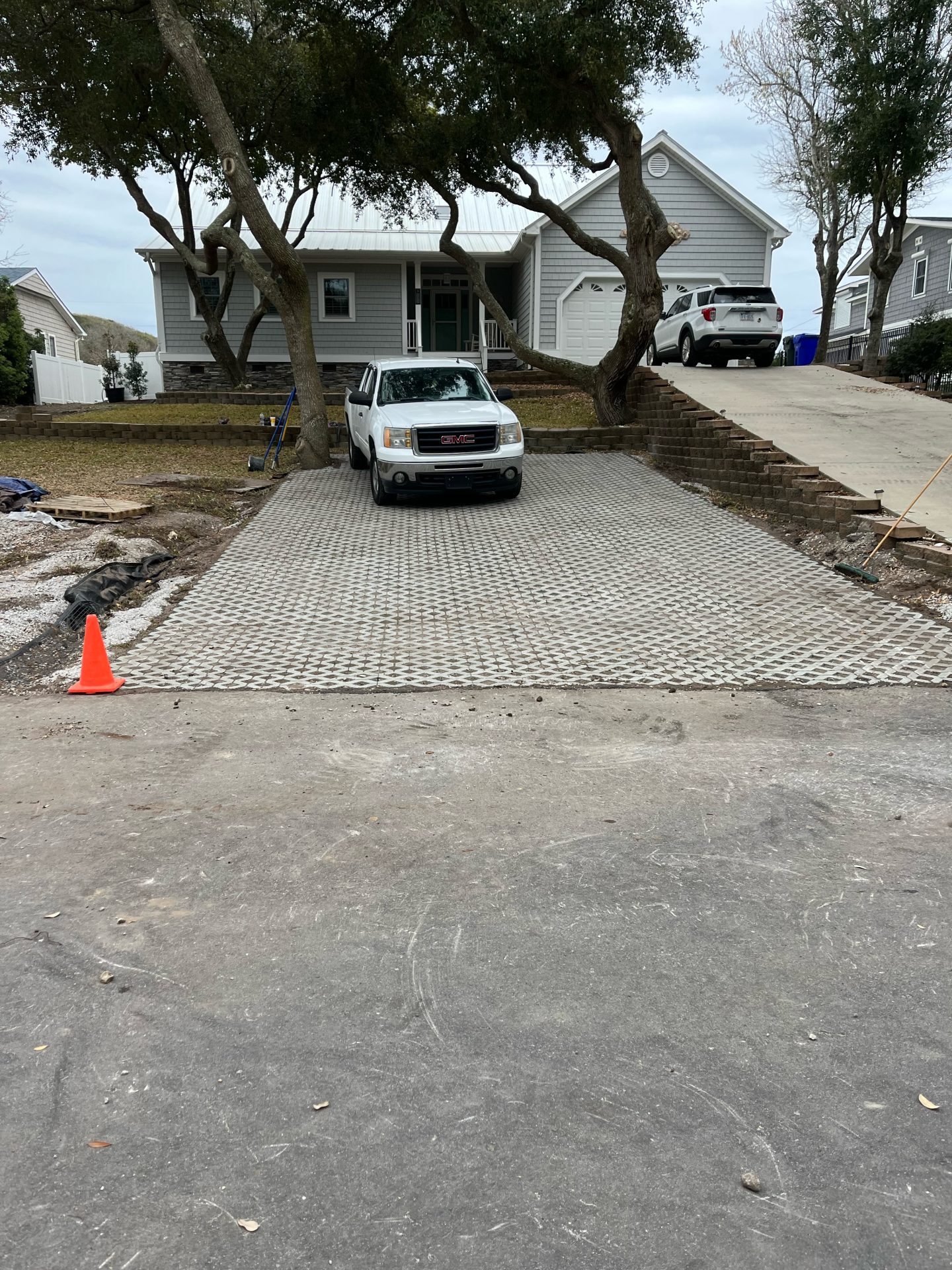 Driveway with parked cars in front of house.