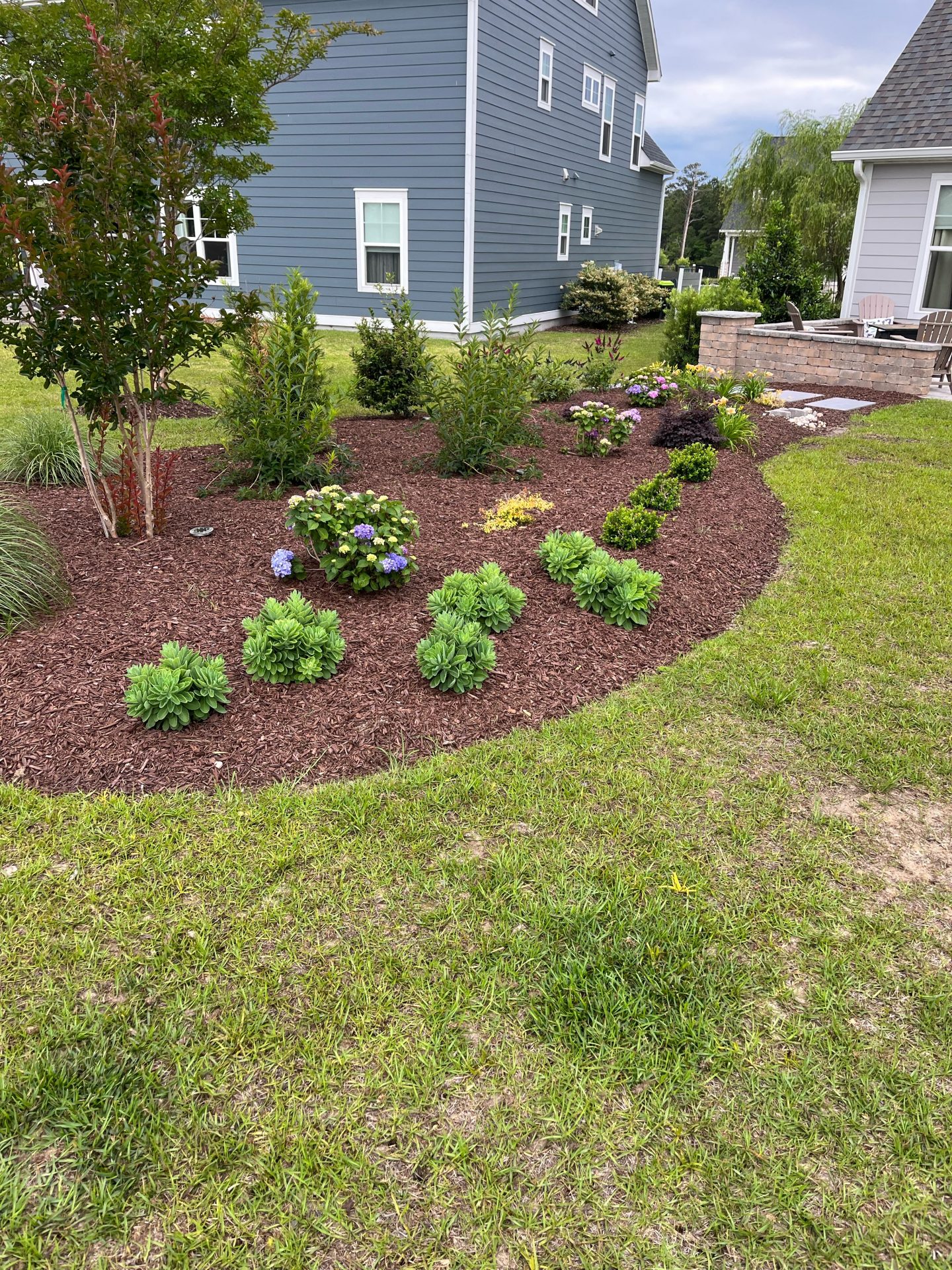 Manicured garden with colorful flowers and shrubs.
