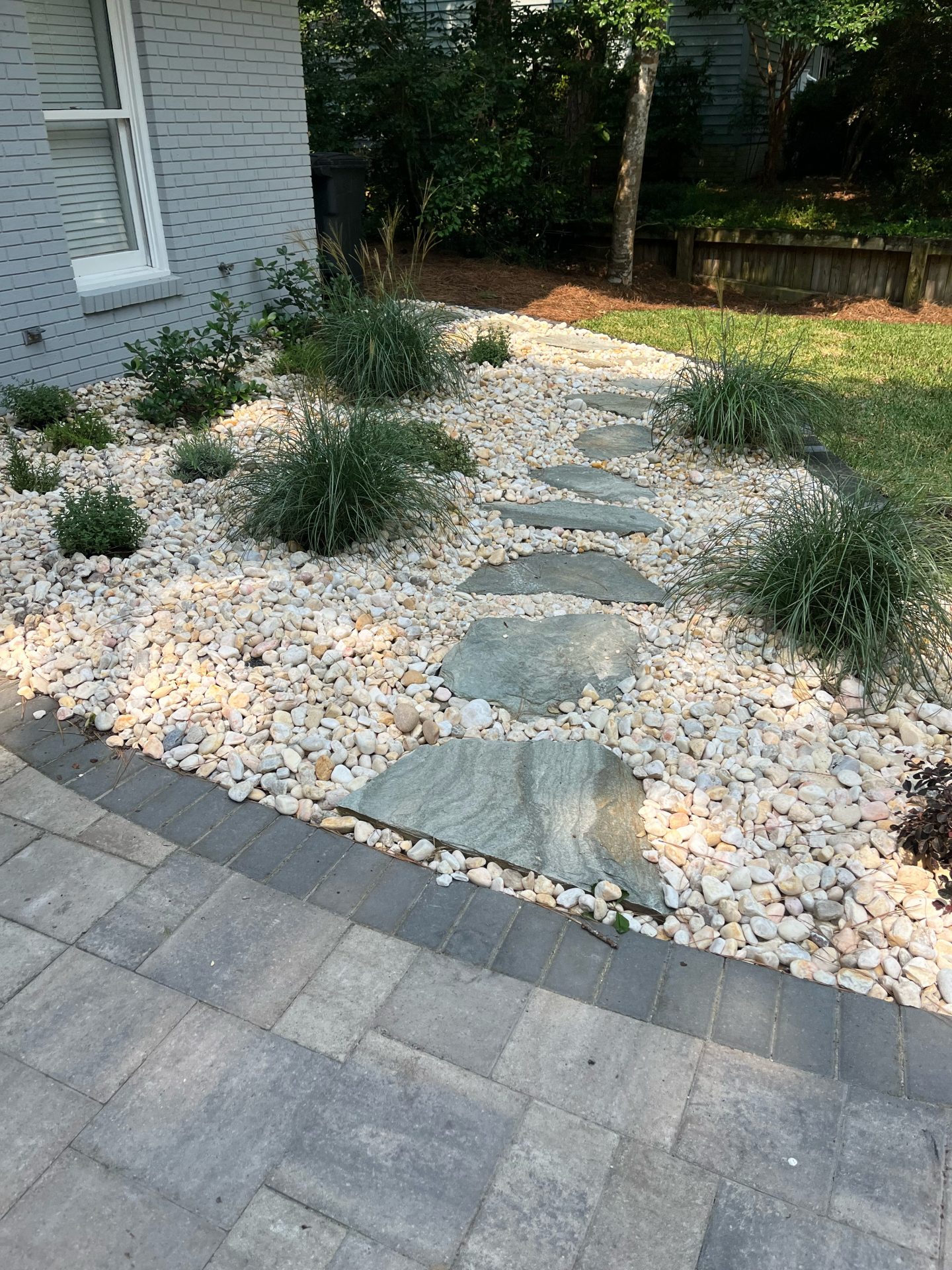 Stone pathway surrounded by gravel and plants