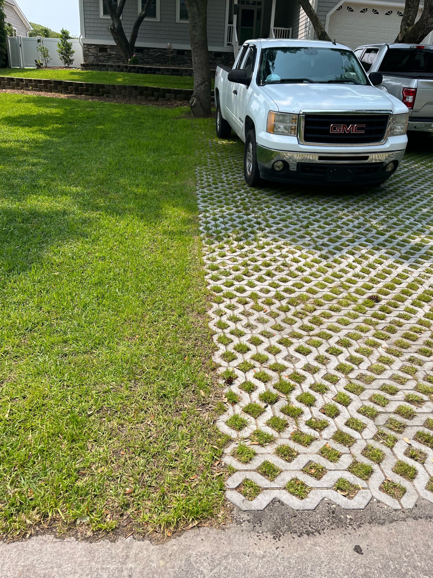 White truck parked on green grass driveway