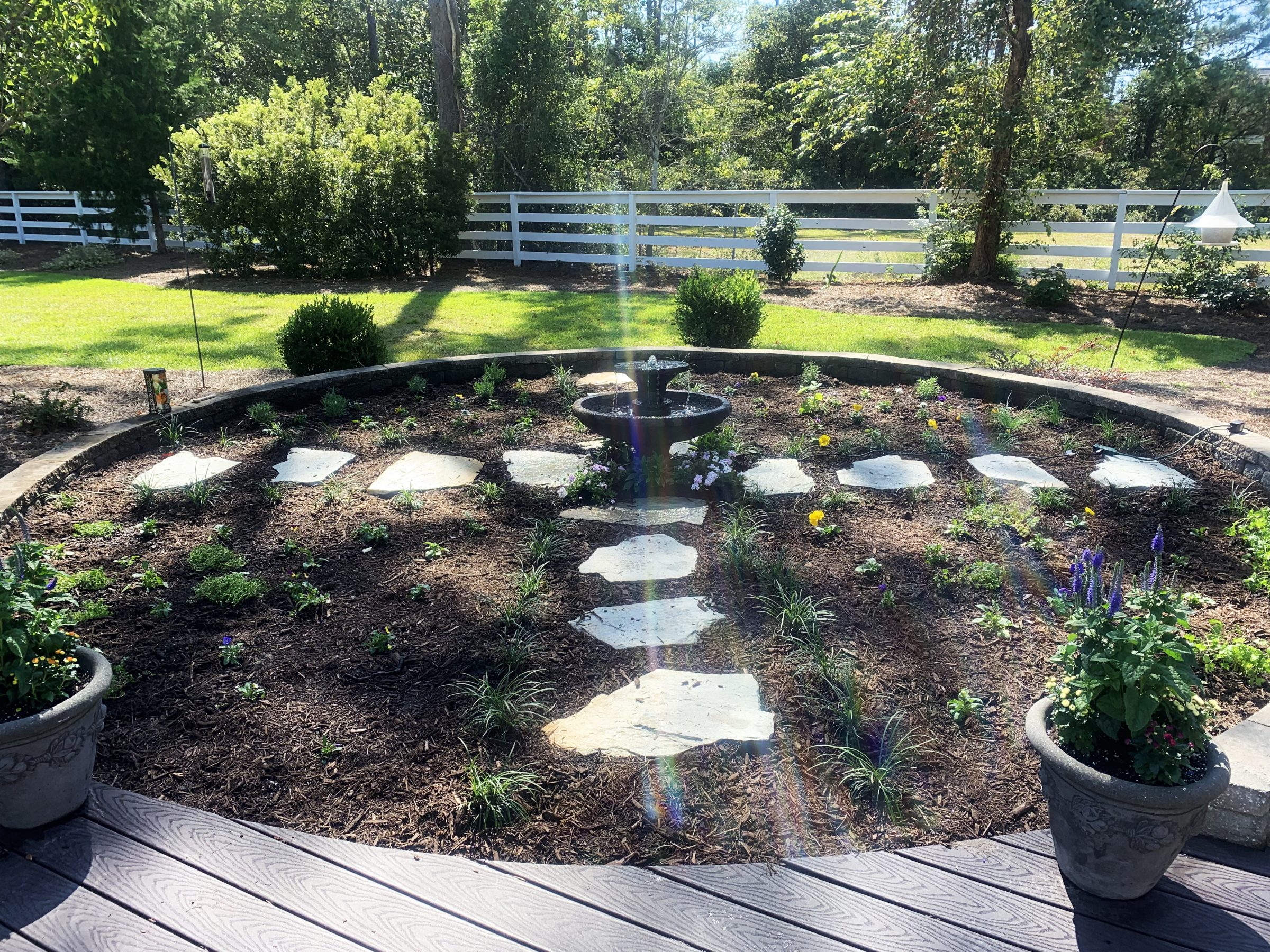 Circular garden with stone path and fountain