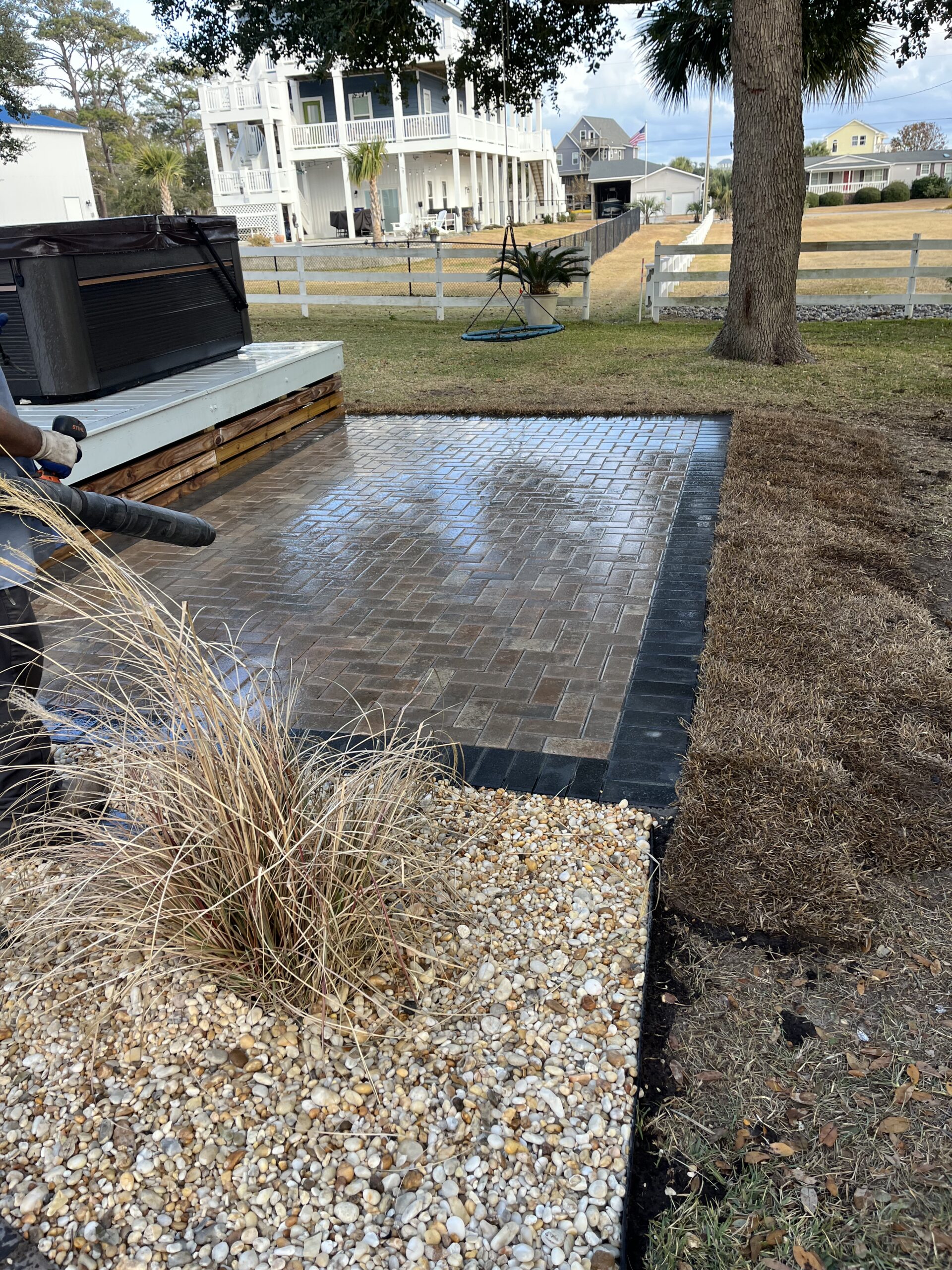 Backyard patio with pavers and landscaping.