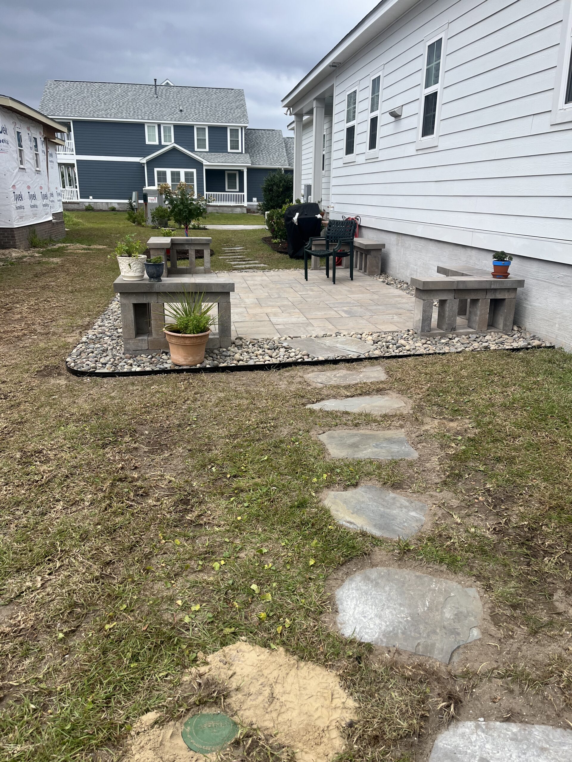 Backyard patio with stone path and benches.