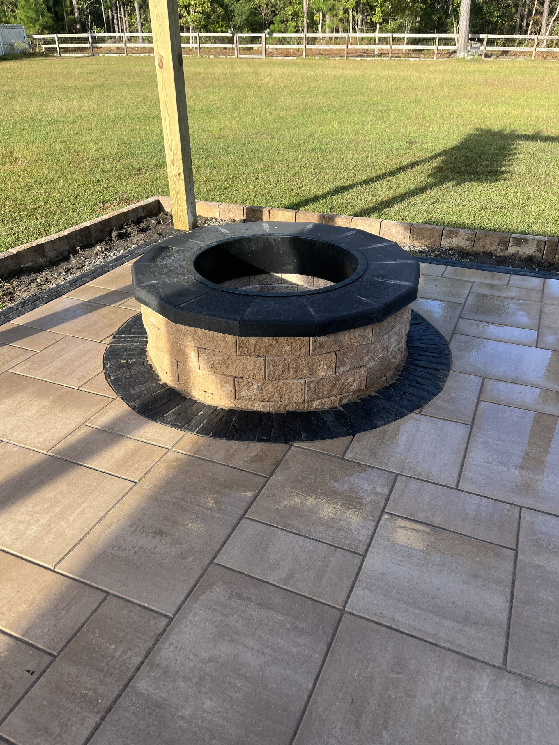 Backyard fire pit on paved patio