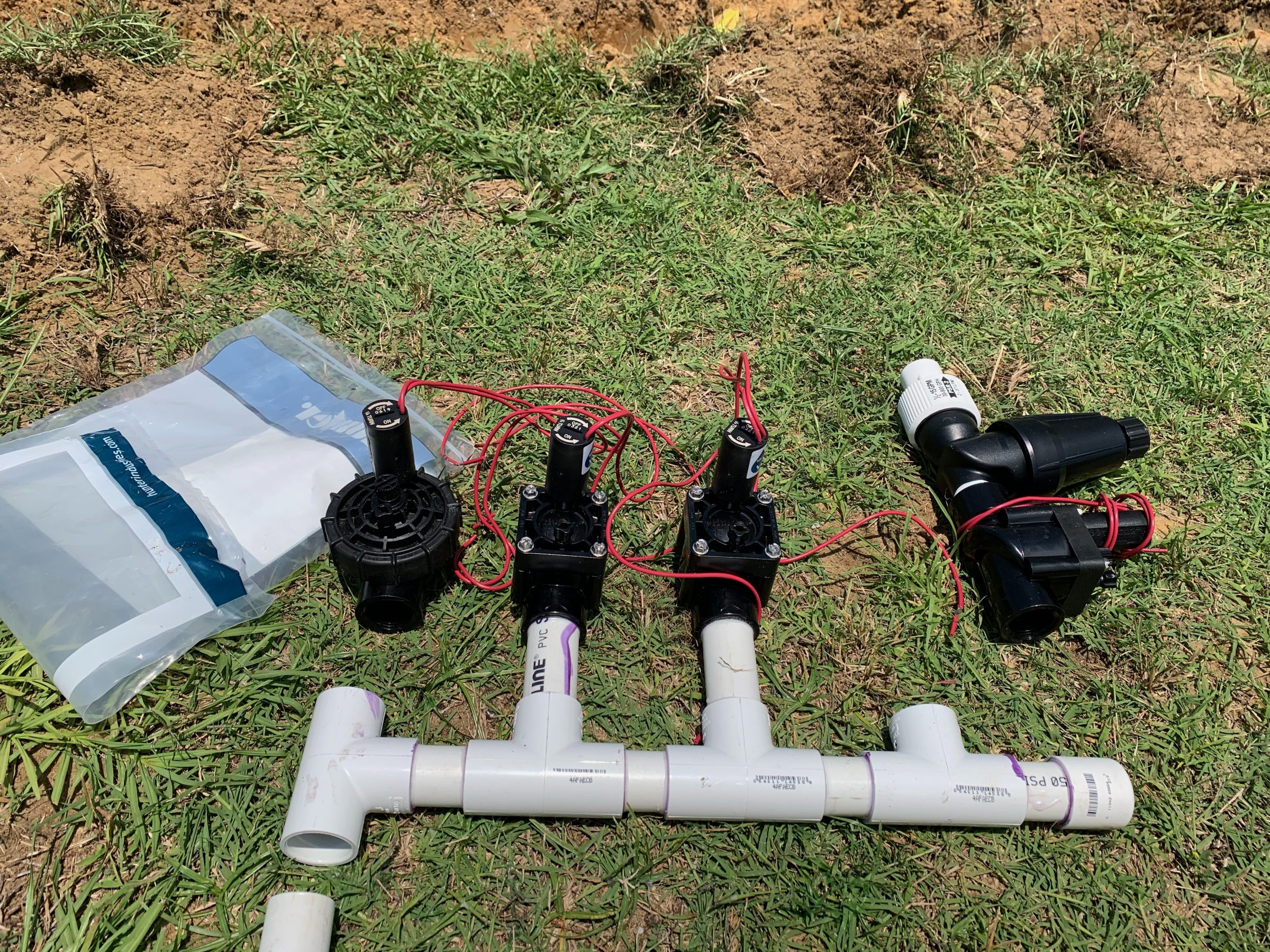 Irrigation system parts on grassy ground