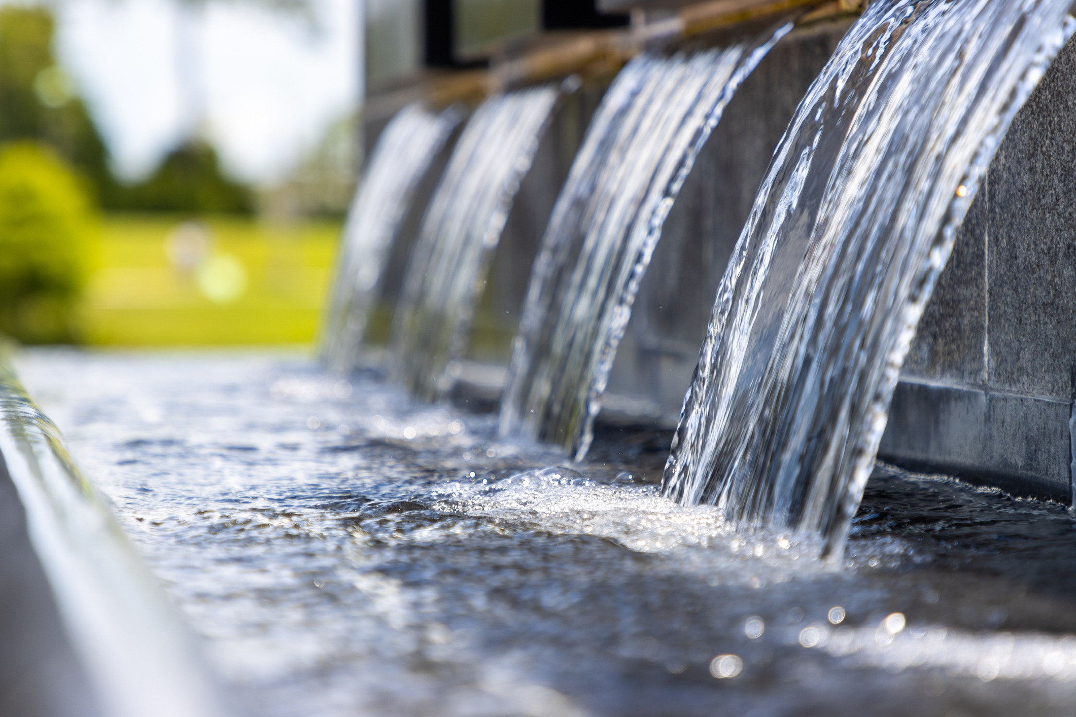 Close-up of water cascading over stone ledges.