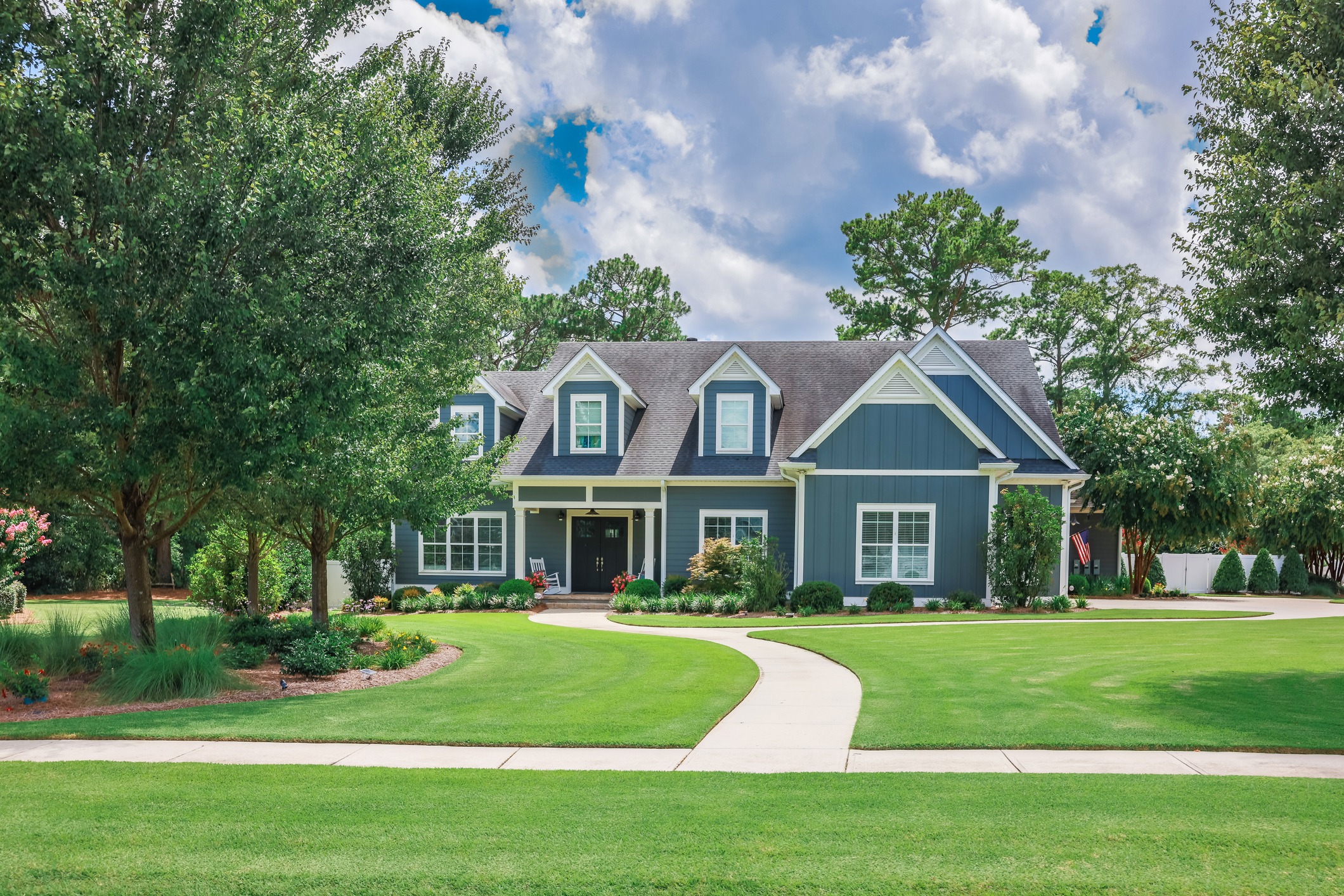 Suburban house with landscaped yard and pathway.