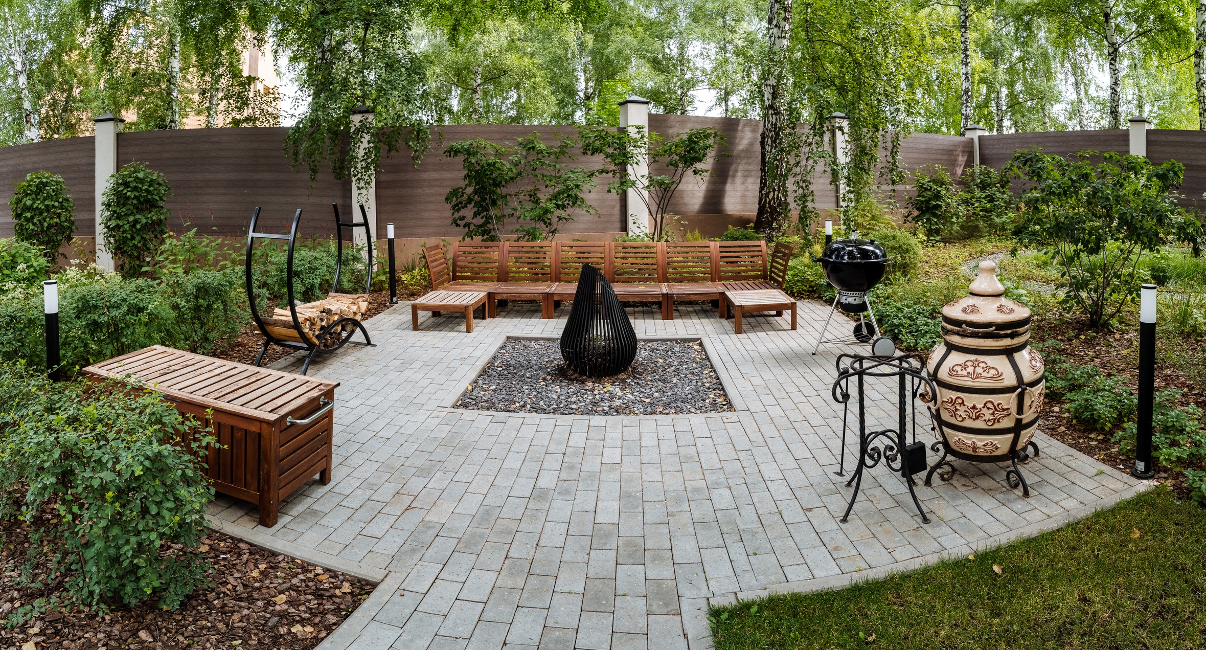 Outdoor patio with fire pit and seating area.