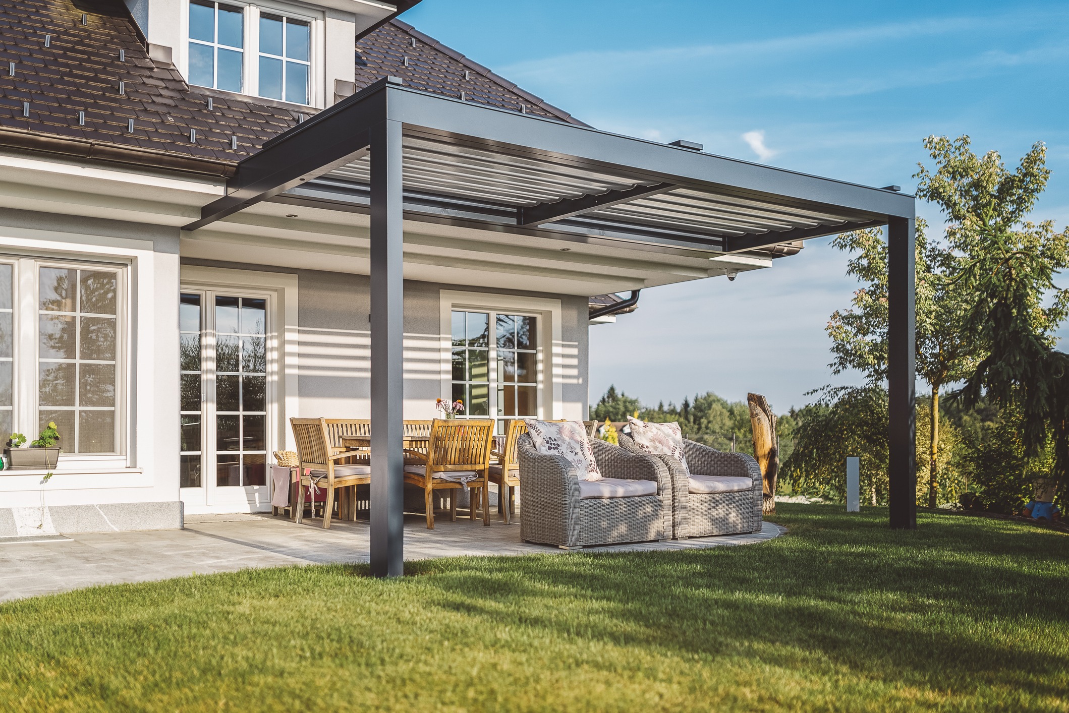 Modern patio with canopy and outdoor seating.